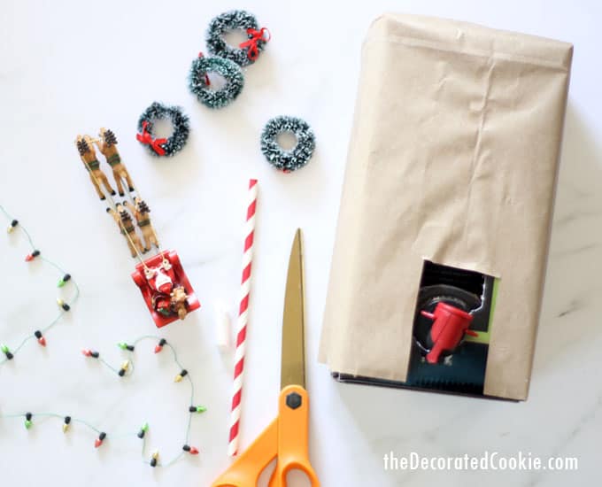 Decorating a box of wine to look like a gingerbread house