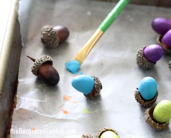 painting acorns on baking tray 