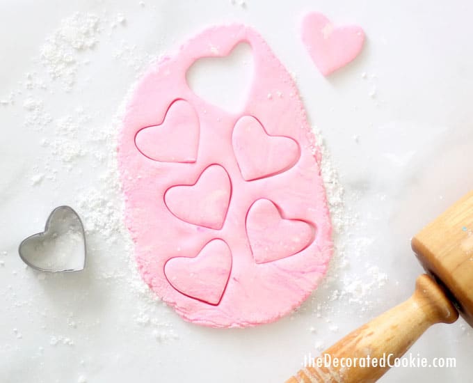 rolling and cutting out homemade conversation heart candy 