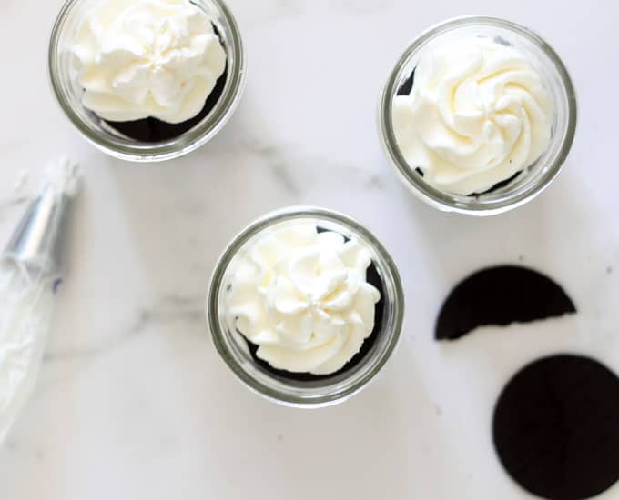 This vodka ice box cake in a jar is a delicious, no-bake, overnight dessert idea combining chocolate wafers, whipped cream, and vodka. Individual servings in a mason jar. Whipped cream vodka recipe. 