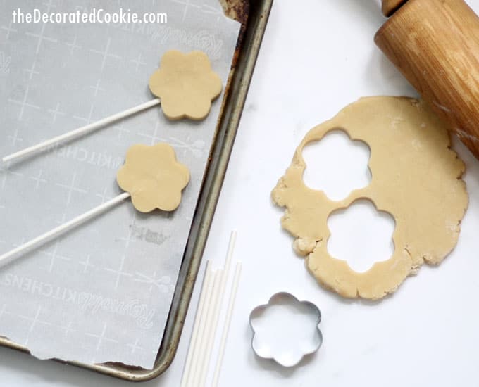 cutting out flower cookies from dough 