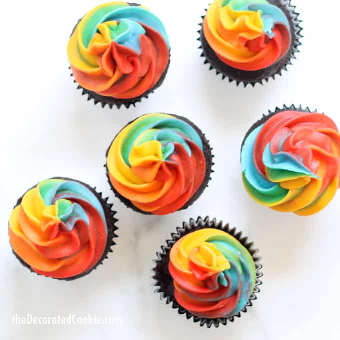 A step-by-step tutorial, with video, how to decorate rainbow swirl cupcakes with buttercream frosting. Easy, fun dessert for a rainbow or unicorn party. #rainbowfood #unicornfood #RainbowParty #cupcakes #buttercreamfrosting #RainbowSwirl