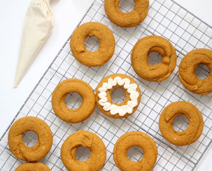 These 2-ingredient pumpkin donuts, baked, not fried, are so easy to make with cake mix and pumpkin puree. A perfect treat for fall and Halloween. #pumpkin #donuts #doughnuts #fall #Halloweendesserts #falldesserts #pumpkindonuts #doughnuts #2ingredient