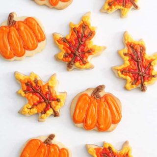 These pumpkin and leaf fall cookies are a fun food craft for autumn, Thanksgiving, school bake sales, and fall fests. #cookiedecorating #fallcookies #Thanksgiving #desserts #partyfavors #bakesale #pumpkins #leaf