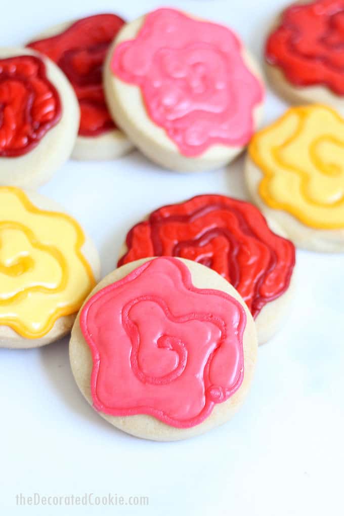 EASY ROSE COOKIES decorated with two colors of royal icing on circle cookies.