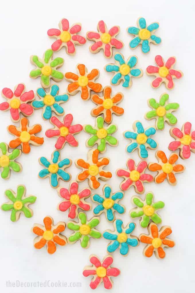 How to decorate MINI DAISY COOKIES with royal icing on cut-out sugar cookies. Colorful flower cookies for Spring or Mother's Day. Package in mason jars for a homemade gift idea. 