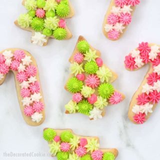 Christmas tree and candy cane cookies with pink and green buttercream frosting decoration
