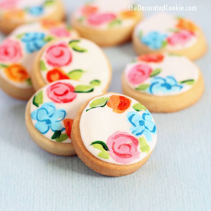 painted flower cookies on blue background 