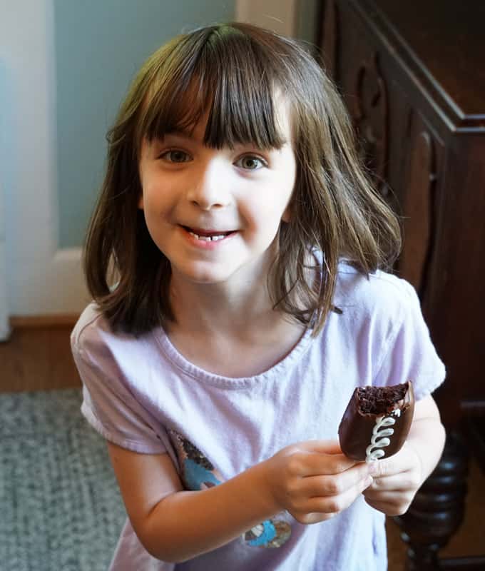 little girl eating "Hostess" cakesicles