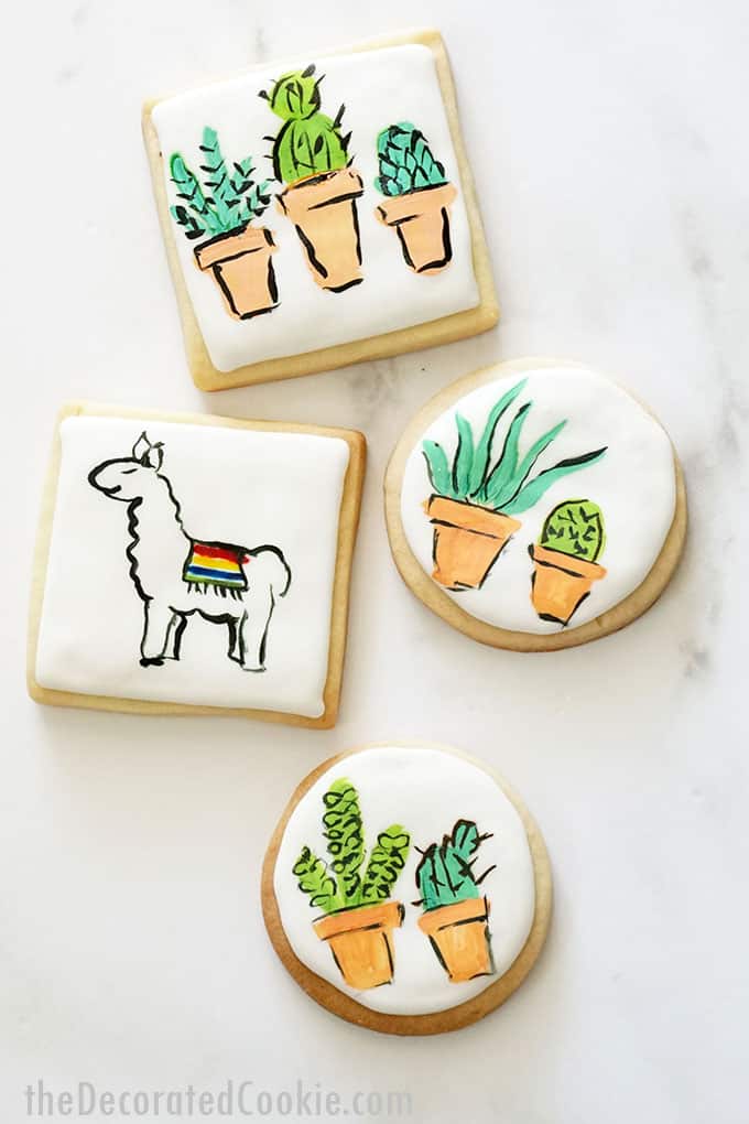 overhead view of llama and succulent painted cookies