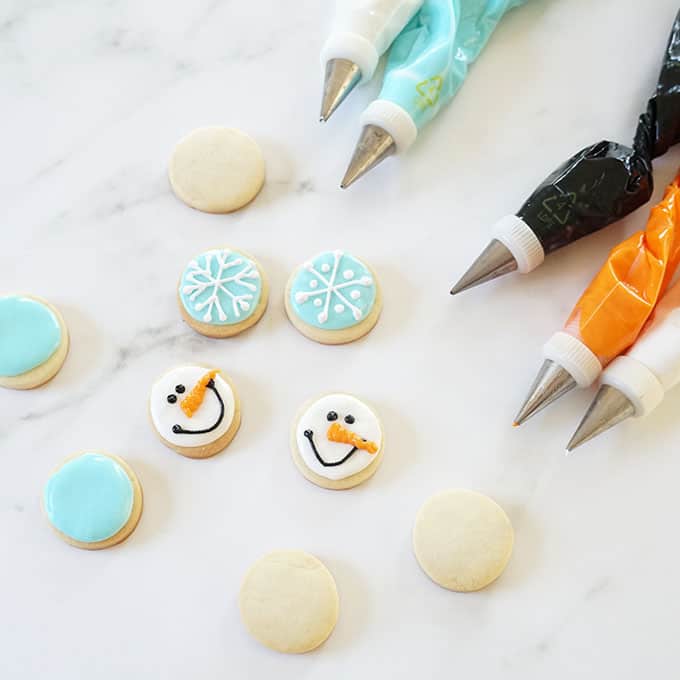 icing bags and mini snowman and snowflake cookies 