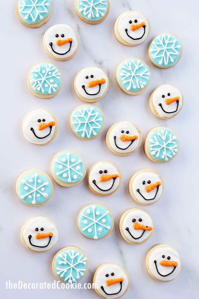 overhead view of snowman and snowflake cookies