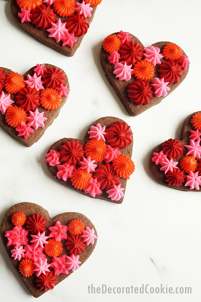 overhead image of Valentine's Day chocolate cookie hearts with frosting