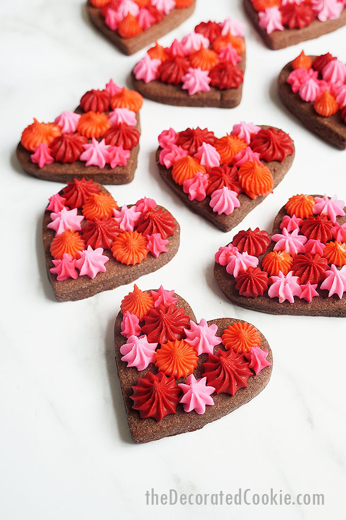 overhead image of Valentine's Day chocolate cookie hearts with frosting