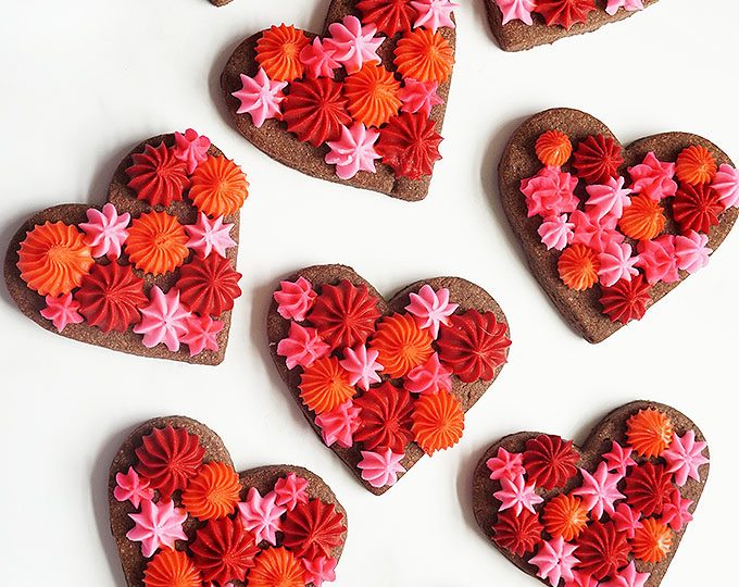 overhead image of Valentine's Day chocolate cookie hearts with frosting