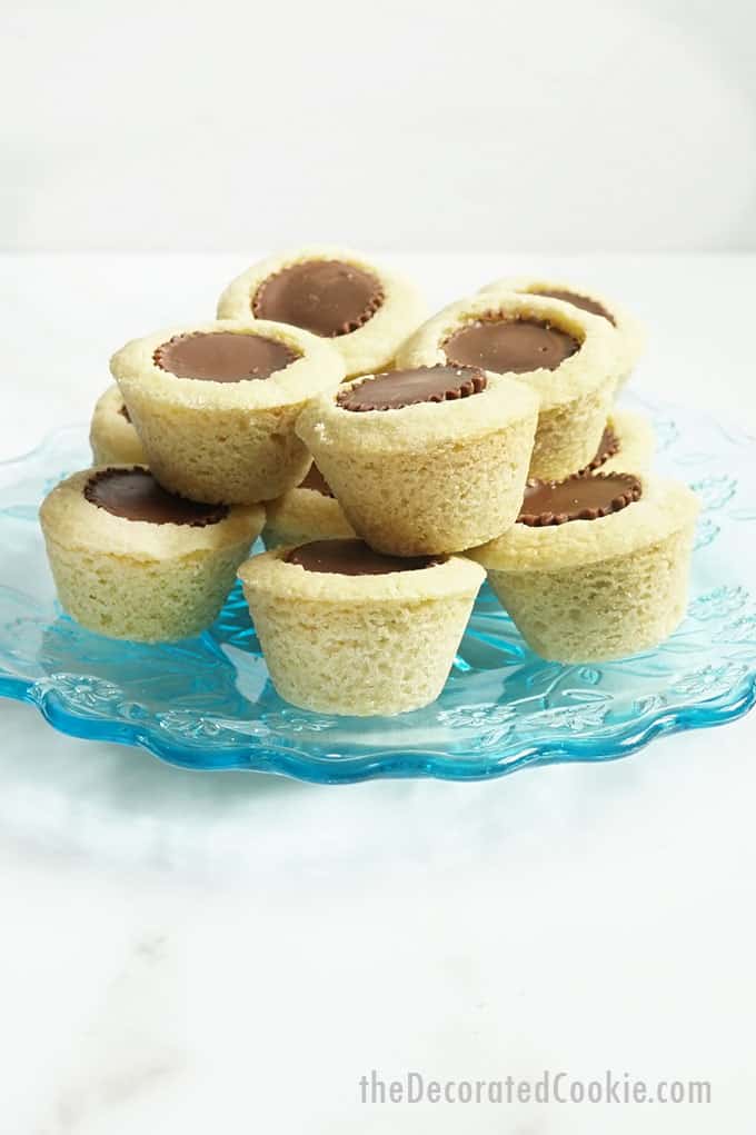 gluten free sugar cookies with REese's peanut butter cups on blue uplate