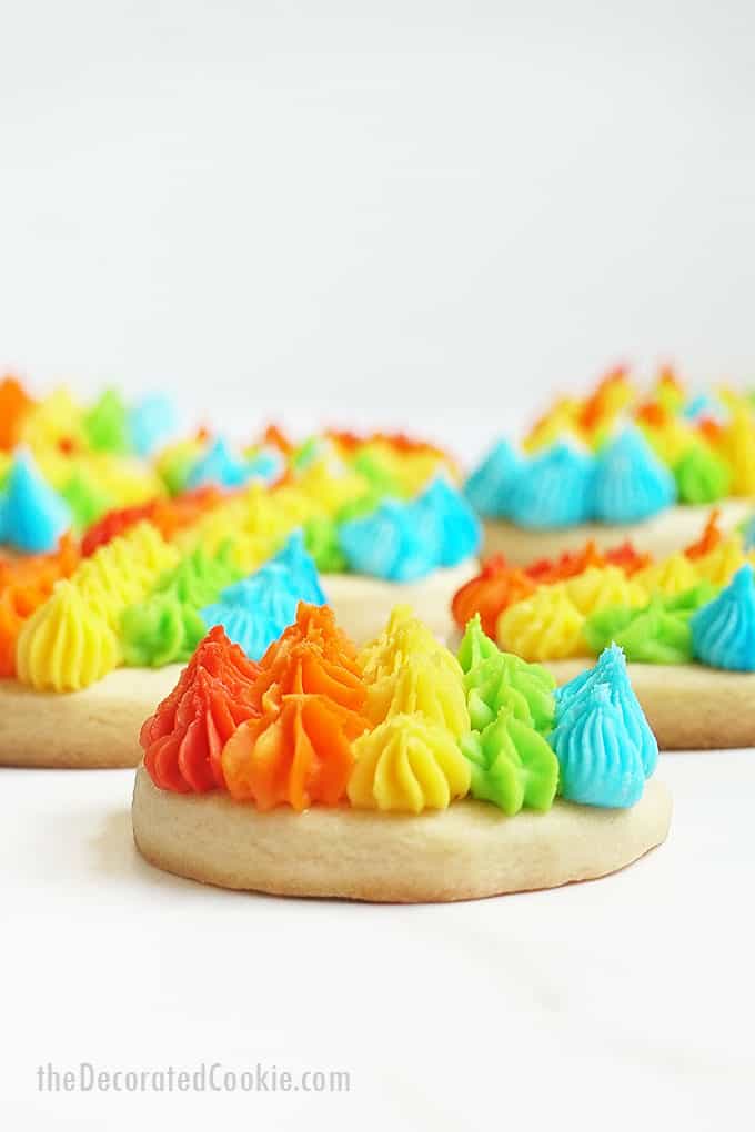 close-up of piped rainbow cookies with frosting