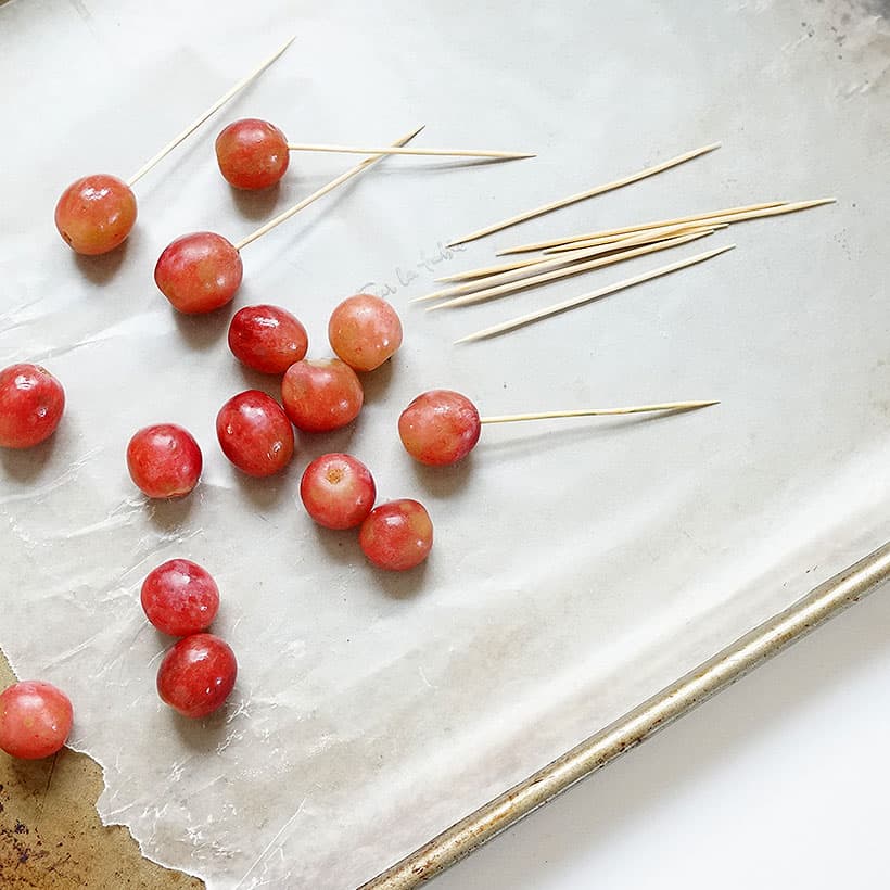 skewering grapes with toothpicks